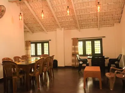 a dining room with a table and chairs at Fogland Villa in Vaduvanchal