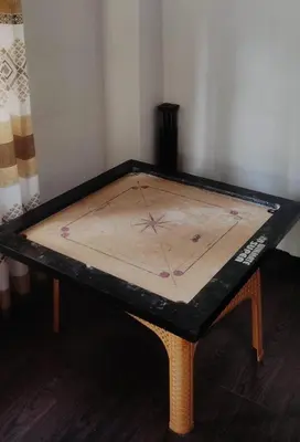 a table with a board on top of it at Fogland Villa in Vaduvanchal