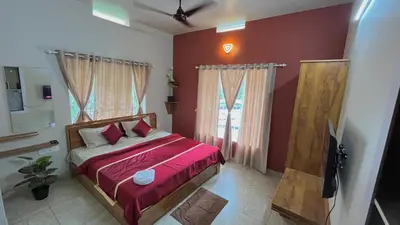 a bedroom with a bed with red walls and a window at Vintage Coffee Premium Villa in Pinangode