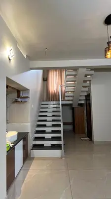 a stairway in a kitchen with a staircase in a room at Vintage Coffee Premium Villa in Pinangode