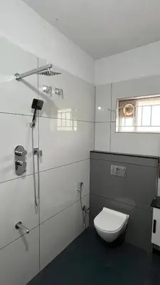 a white bathroom with a toilet and a shower at Vintage Coffee Premium Villa in Pinangode