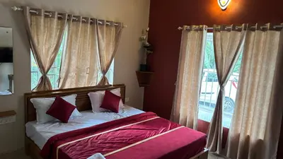 a bedroom with a bed with pink sheets and a window at Vintage Coffee Premium Villa in Pinangode