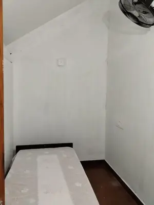 a white room with a bed in it at Ophel Homestay, 7 Bed Heritage Home in Mananthavady