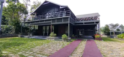 a large house with a balcony and a yard at Ranches & Kennels 2BR Coorg in Kushālnagar
