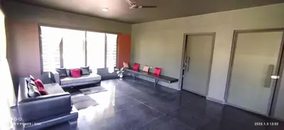 a living room with couches and a large window at Ranches & Kennels 2BR Coorg in Kushālnagar