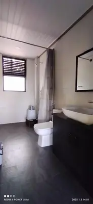 a bathroom with a toilet and a tub and a sink at Hidden Haven 1BR Coorg in Kushālnagar