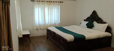 a bedroom with a bed and a window at Hills Dale ooty 3 bhk vintage tea estate villa in Ooty