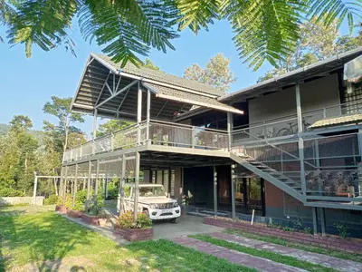 a house with a car parked in front of it at Coorg Countryside 1BR in Kushālnagar