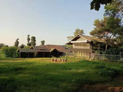 a house with a yard in front of it at Coorg Countryside 1BR in Kushālnagar