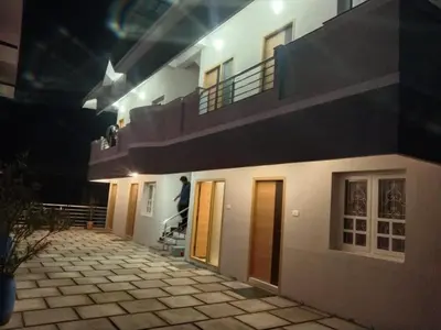 a man standing on a stairwell of a building at Little heaven in Ooty