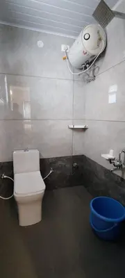 a bathroom with a toilet and a camera on the wall at Little heaven in Ooty