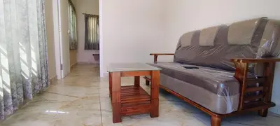 a living room with a couch and a table at Little heaven in Ooty