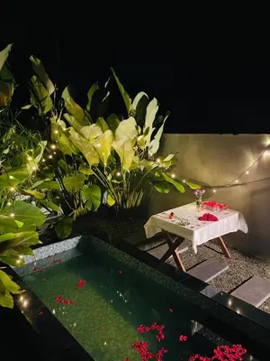 a garden with a table and some flowers at Cherry Blossoms Chalet in Kozhikode