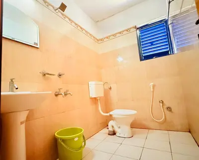 a bathroom with a toilet and a sink at K M S Residency in Tirūr