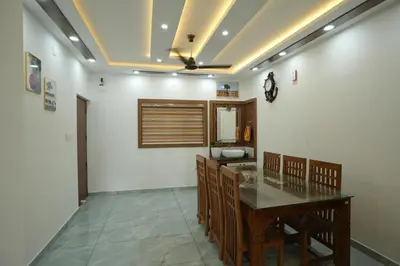 a dining room with a table and a mirror at Wayanadanhuts Home Stay in Sultan Bathery