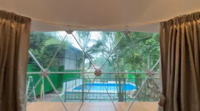 a room with a window with a view of a pool at Rivergreen resort in Athirappally