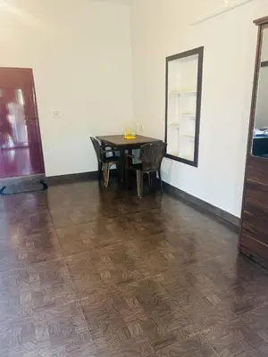 a dining room with a table and a mirror at ROYAL HOLIDAY HOMe in Ambalavayal