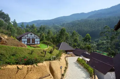 a house on the side of a hill at Koviloor Resort in Vattavada