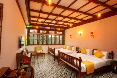 a bedroom with two beds in a room at Koviloor Resort in Vattavada