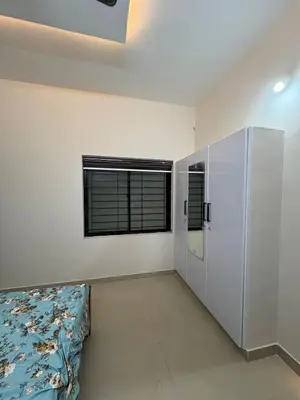 a living room with a couch and a window at AC Arcade in Parli