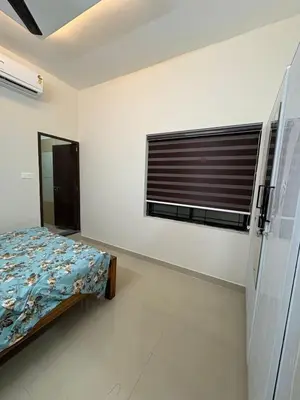 a bedroom with a bed and a window at AC Arcade in Parli