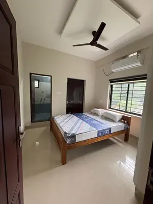 a bedroom with a bed and a ceiling fan at AC Arcade in Parli