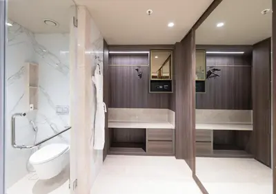 a bathroom with a toilet and a sink at Merlis Hotel Coimbatore in Coimbatore