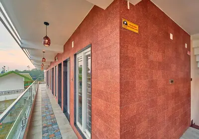 a red brick wall with a sign on it at Ooty Blossom Retreat by VOYE HOMES in Ooty