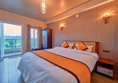 a bedroom with a large bed and a large window at Ooty Blossom Retreat by VOYE HOMES in Ooty