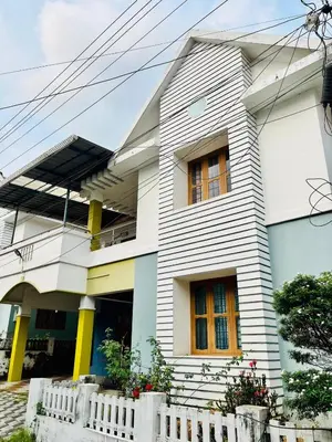 a white house with yellow windows and a fence at 3BHK Spacious Villa near Rajagiri Hospital in Ernakulam