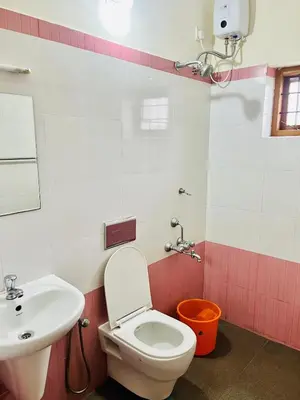 a bathroom with a toilet and a sink at 3BHK Spacious Villa near Rajagiri Hospital in Ernakulam
