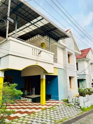a white building with yellow and blue at 3BHK Spacious Villa near Rajagiri Hospital in Ernakulam