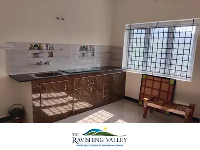 a kitchen with a counter top and a window at Ravishing Valley in Ketti