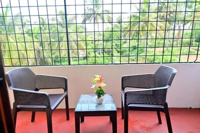 two chairs and a table in front of a large window at GVK Holiday Inn in Mysore