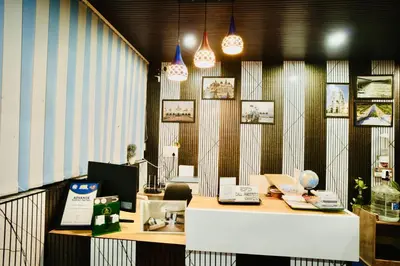 an office with a desk and chairs and pendant lights at GVK Holiday Inn in Mysore