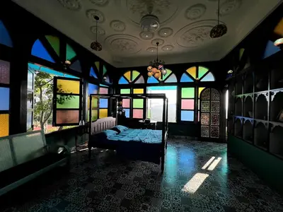 a bedroom with a bed in a room with windows at Room Marakkech Mazha at Samava Farms Calicut in Kozhikode