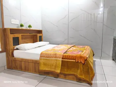 a bedroom with a bed in a room at Diyara's Inn in Madikeri