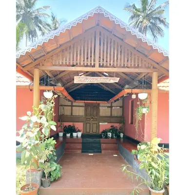a entrance to a building with a sign on it at Coffeeisland vintage stay in Meenangadi