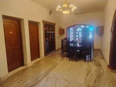 a dining room with a table and chairs in a room at Hotel Vintage Palace in Tattamangalam