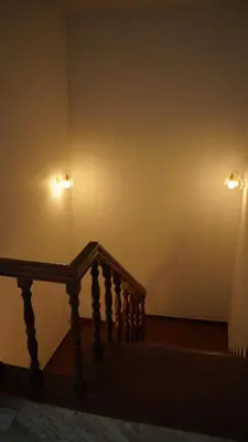 two lights on a wall next to a stair case at Hotel Vintage Palace in Tattamangalam