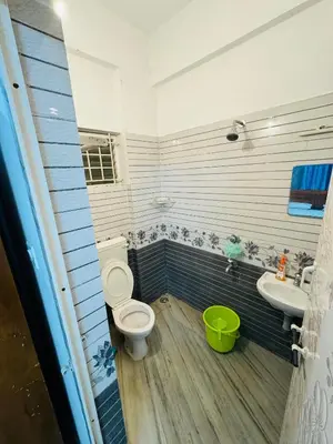 a bathroom with a toilet and a sink at Harmony Nests in Thattakād