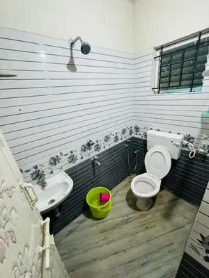 a bathroom with a toilet and a sink at Harmony Nests in Thattakād