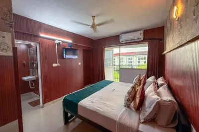 a bedroom with a bed and a sliding glass door at Mayflower Family Lounge -Cochin Airport in Nedumbassery