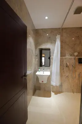a bathroom with a sink and a mirror at Kaayal Experience - Entire Home in Kozhikode in Kozhikode