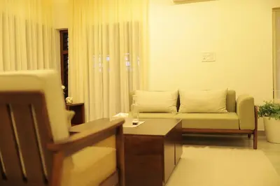 a living room with a couch and a table at Kaayal Experience - Entire Home in Kozhikode in Kozhikode
