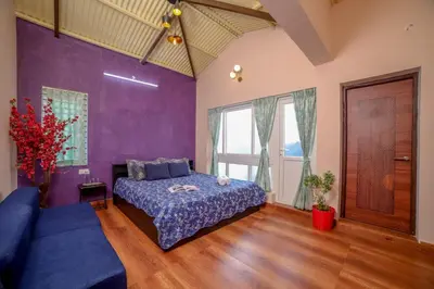 a bedroom with purple walls and a bed and a couch at Spring Fields in Coimbatore