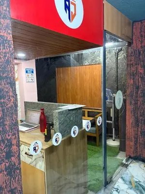 a counter with stickers on the window of a restaurant at AJ GrandInn in Podanūr