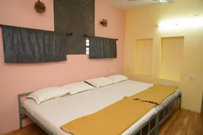 a bedroom with two beds in a room at AJ GrandInn in Podanūr