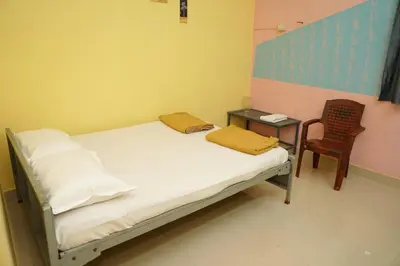 a hospital room with a bed and a chair at AJ GrandInn in Podanūr