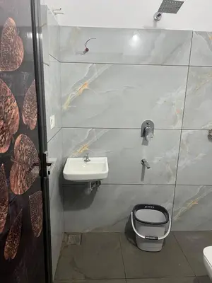 a bathroom with a toilet and a sink at Mynakam - A peaceful escape in Vythiri